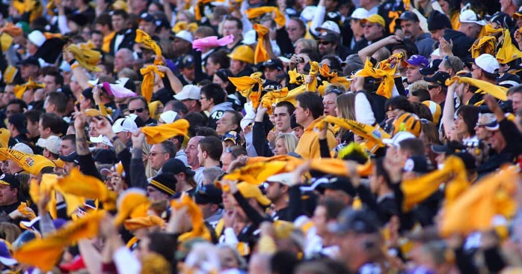 Steelers fans waving Terrible Towels during a home game at Acrisure Stadium